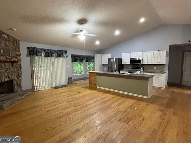 161 Cedar Cove Dr, Buckhead, GA 30625 - kitchen featuring stainless steel appliances, a ceiling fan, white cabinetry, lofted ceiling, and light wood-style floors