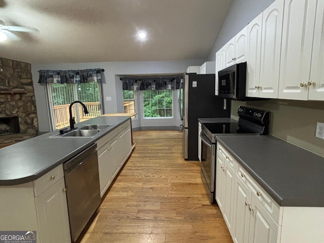 161 Cedar Cove Dr, Buckhead, GA 30625 - kitchen with stainless steel appliances, a sink, light wood-style floors, dark countertops, and white cabinets