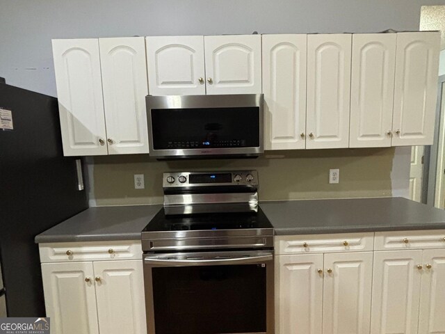 161 Cedar Cove Dr, Buckhead, GA 30625 - kitchen with appliances with stainless steel finishes, white cabinets, and dark countertops