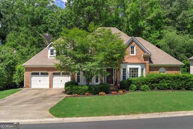 4381 Laurian Dr NW, Kennesaw, GA 30144 - view of front of home featuring concrete driveway, a front yard, brick siding, and a garage
