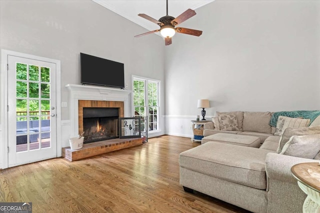 4381 Laurian Dr NW, Kennesaw, GA 30144 - living room featuring wood finished floors, ceiling fan, a brick fireplace, and a high ceiling