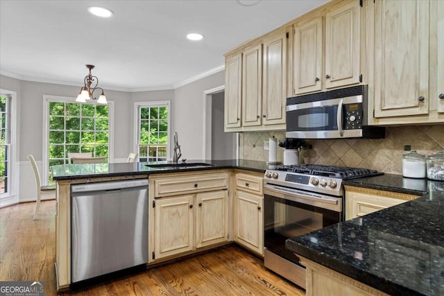 4381 Laurian Dr NW, Kennesaw, GA 30144 - kitchen with appliances with stainless steel finishes, a peninsula, light brown cabinets, light wood-style floors, and crown molding