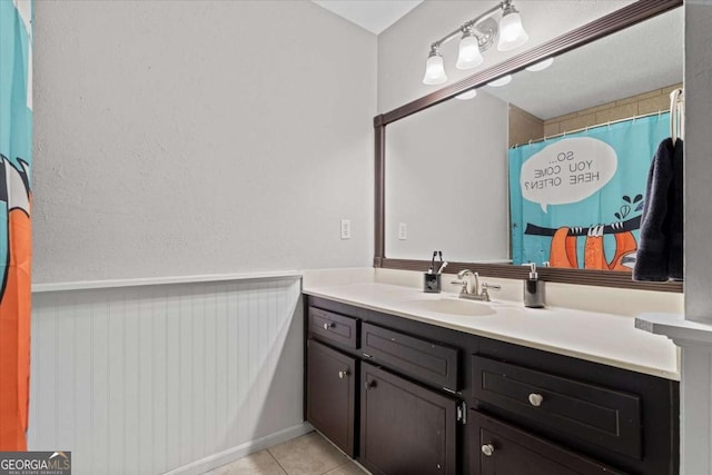 4381 Laurian Dr NW, Kennesaw, GA 30144 - full bath featuring vanity, tile patterned floors, and wainscoting
