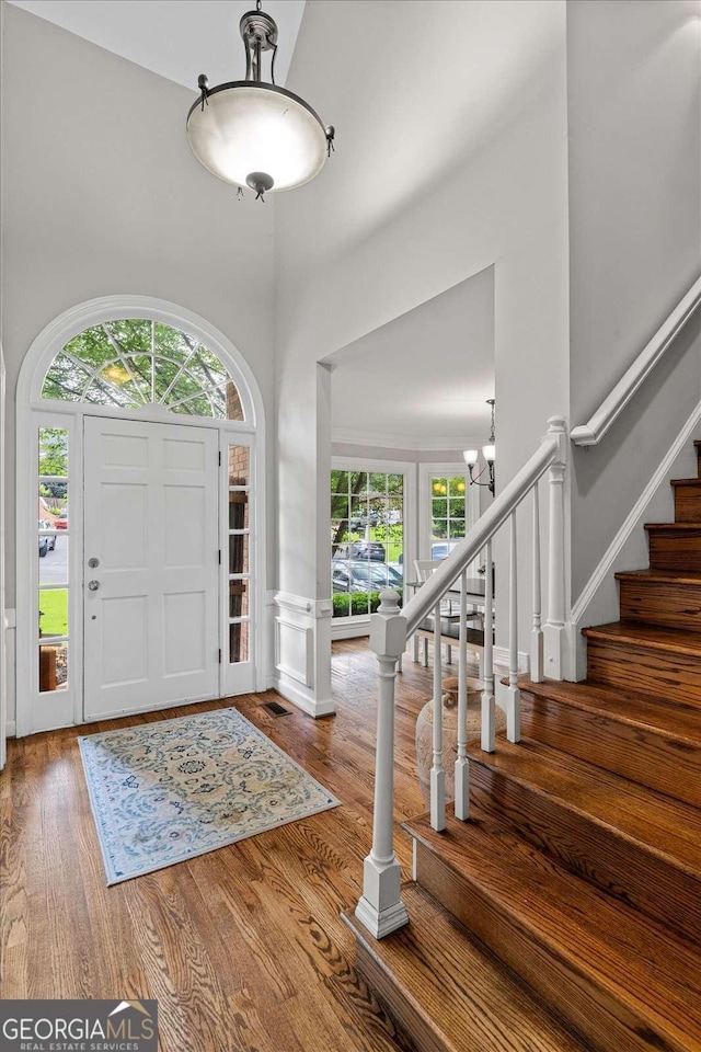 4381 Laurian Dr NW, Kennesaw, GA 30144 - foyer entrance with a towering ceiling, wood finished floors, and stairway