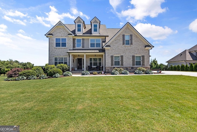 1858 Switchgrass Dr, Statham, GA 30666 - view of front of house with brick siding, a front lawn, and a porch