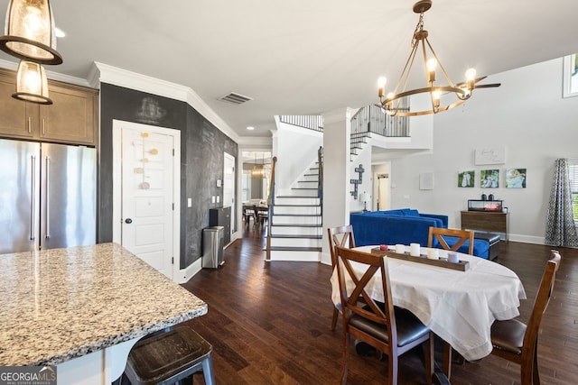 1858 Switchgrass Dr, Statham, GA 30666 - dining room featuring a chandelier, baseboards, stairway, dark wood finished floors, and ornamental molding