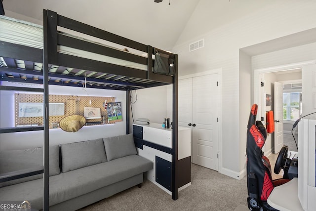 1858 Switchgrass Dr, Statham, GA 30666 - carpeted bedroom featuring a closet, high vaulted ceiling, and baseboards