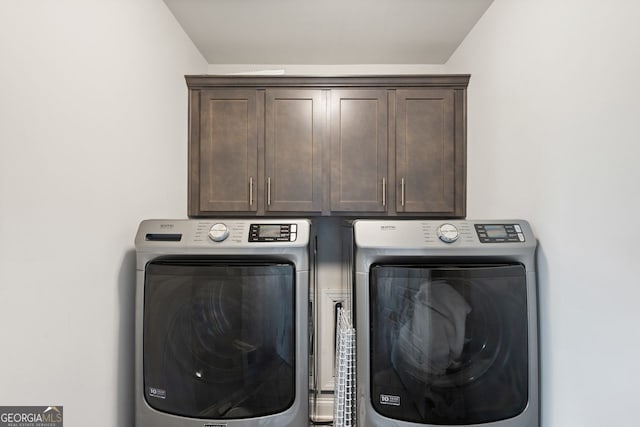 1858 Switchgrass Dr, Statham, GA 30666 - laundry room with washing machine and dryer and cabinet space