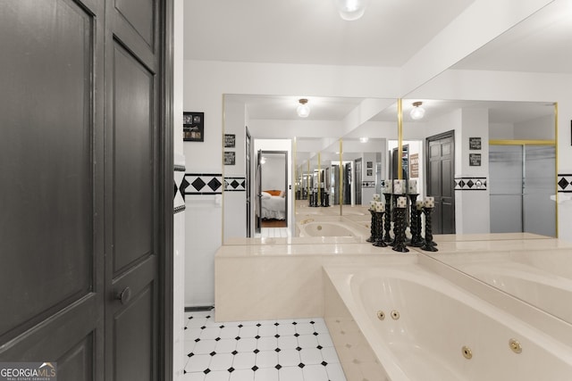 231 Doug Allison Hts, Cleveland, GA 30528 - bathroom featuring a whirlpool tub, vanity, a closet, wainscoting, and ensuite bath