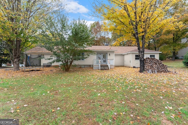 231 Doug Allison Hts, Cleveland, GA 30528 - rear view of house with a yard and a trampoline