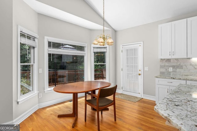 85 Arabian Ave, Alpharetta, GA 30004 - dining space featuring a chandelier, lofted ceiling, light wood-style floors, and baseboards