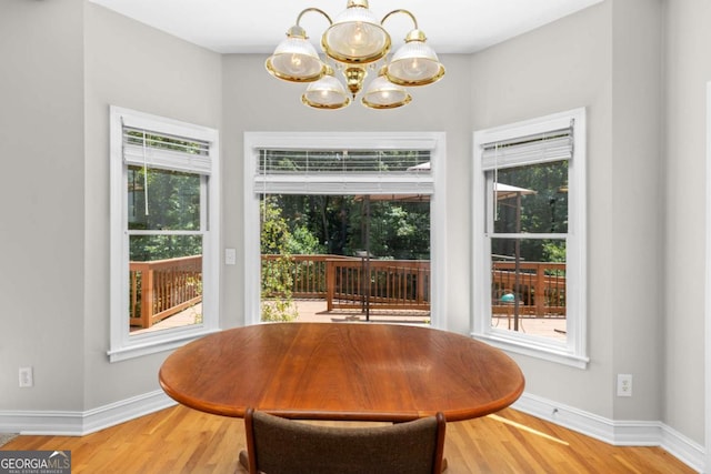 85 Arabian Ave, Alpharetta, GA 30004 - dining room with a chandelier, healthy amount of natural light, and light wood-type flooring
