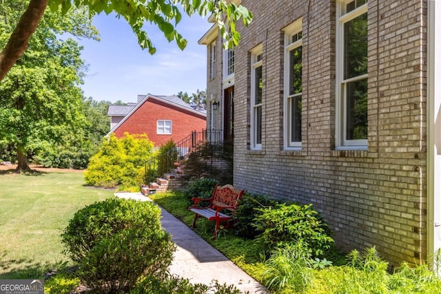 85 Arabian Ave, Alpharetta, GA 30004 - view of side of home featuring brick siding, a yard, and stairway