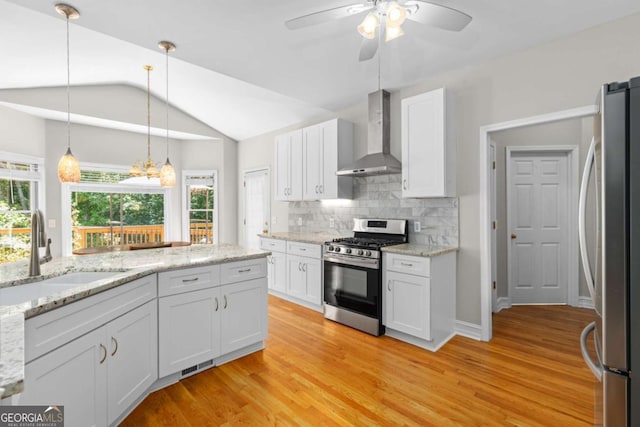 85 Arabian Ave, Alpharetta, GA 30004 - kitchen featuring appliances with stainless steel finishes, wall chimney exhaust hood, a sink, vaulted ceiling, and white cabinetry