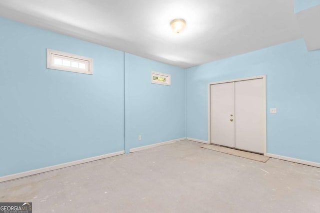 85 Arabian Ave, Alpharetta, GA 30004 - unfurnished bedroom featuring concrete flooring, baseboards, and a closet
