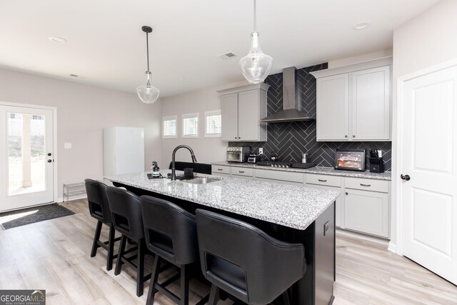 646 Mccarley Downs Dr, Bonaire, GA 31005 - kitchen with a sink, wall chimney exhaust hood, tasteful backsplash, light wood-type flooring, and recessed lighting