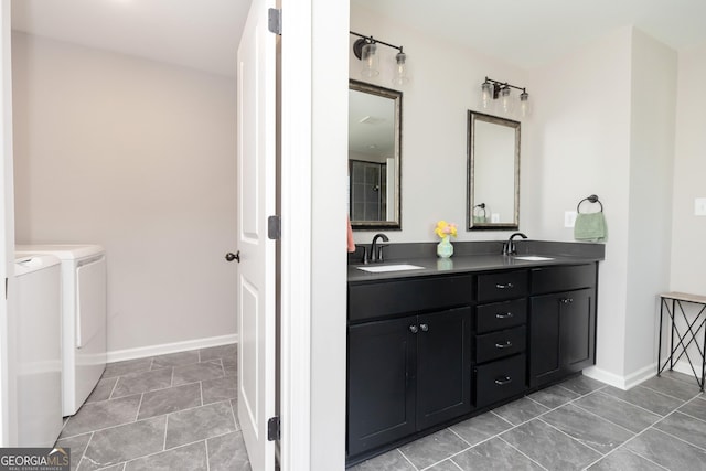 646 Mccarley Downs Dr, Bonaire, GA 31005 - bathroom with independent washer and dryer, double vanity, and baseboards