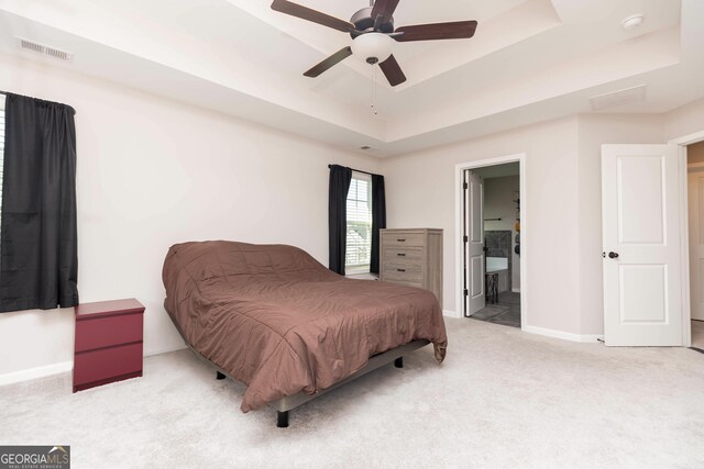 646 Mccarley Downs Dr, Bonaire, GA 31005 - bedroom with a tray ceiling, carpet, baseboards, a ceiling fan, and ensuite bath
