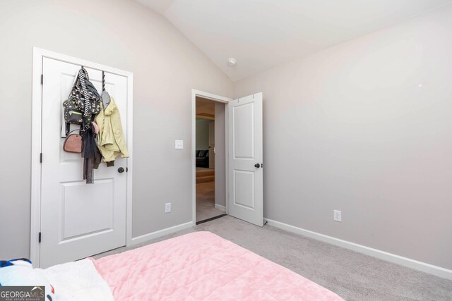 646 Mccarley Downs Dr, Bonaire, GA 31005 - bedroom with vaulted ceiling, light carpet, baseboards, and a closet