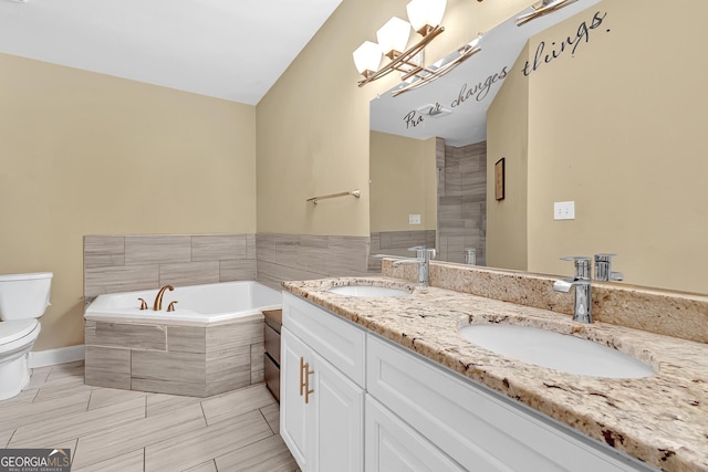 827 Fraser St SE, Atlanta, GA 30315 - bathroom featuring toilet, double vanity, a garden tub, and a chandelier