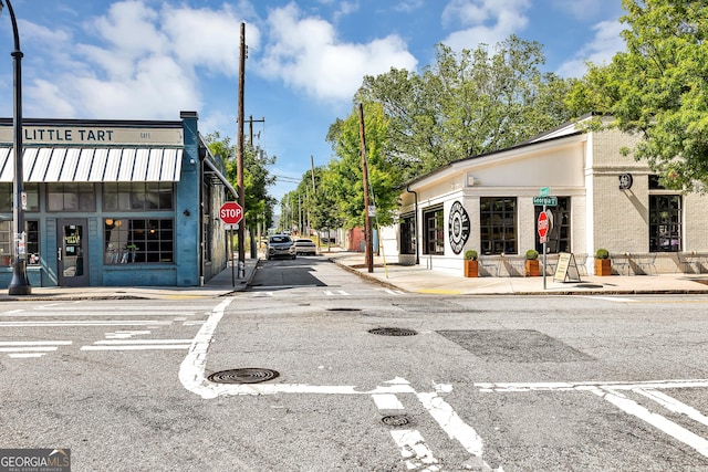 827 Fraser St SE, Atlanta, GA 30315 - view of asphalt road with traffic signs, sidewalks, curbs, and street lights