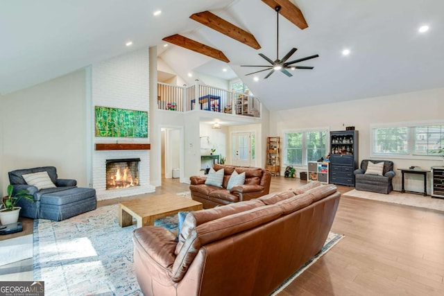 1685 Valley Rd NE, Gainesville, GA 30501 - living area featuring high vaulted ceiling, a fireplace, beamed ceiling, wood finished floors, and ceiling fan