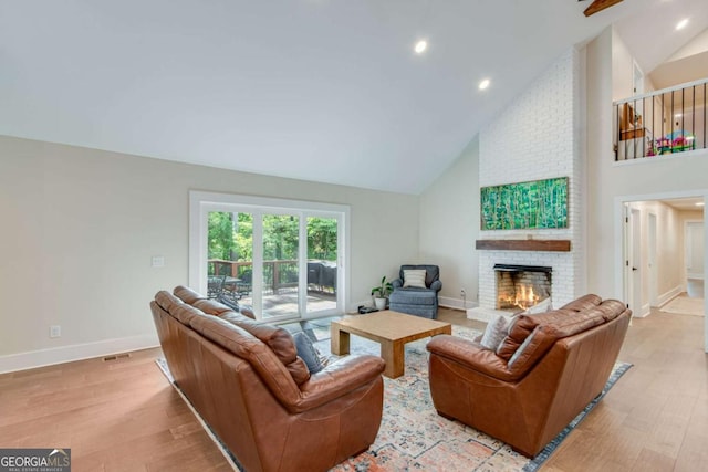 1685 Valley Rd NE, Gainesville, GA 30501 - living room featuring high vaulted ceiling, light wood-style flooring, a brick fireplace, and recessed lighting