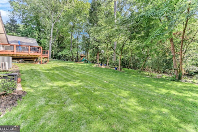 1685 Valley Rd NE, Gainesville, GA 30501 - view of grassy yard with a deck and a playground