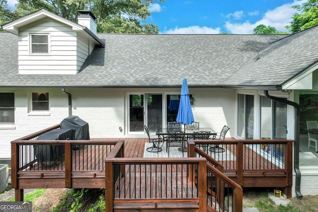 1685 Valley Rd NE, Gainesville, GA 30501 - rear view of house with a shingled roof, brick siding, a deck, outdoor dining space, and a chimney