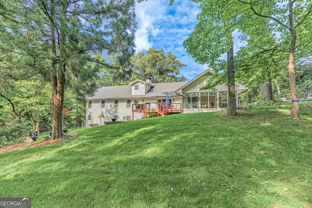1685 Valley Rd NE, Gainesville, GA 30501 - back of house with a sunroom, a chimney, a deck, and a lawn