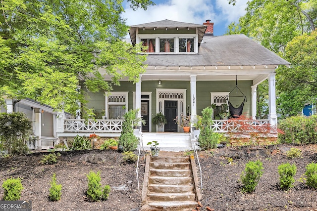 1021 Oak St SW, Atlanta, GA 30310 - view of front of home with a porch, a shingled roof, and a chimney