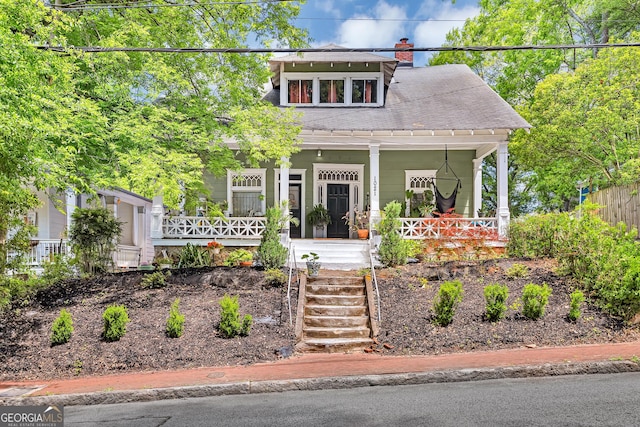 1021 Oak St SW, Atlanta, GA 30310 - view of front of house with a porch, roof with shingles, and a chimney