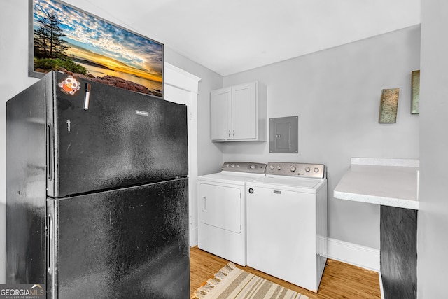 1021 Oak St SW, Atlanta, GA 30310 - laundry area with light wood-style floors, washing machine and clothes dryer, electric panel, and cabinet space
