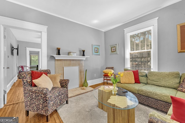 1021 Oak St SW, Atlanta, GA 30310 - living area featuring wood-type flooring, plenty of natural light, a tile fireplace, ornamental molding, and baseboards