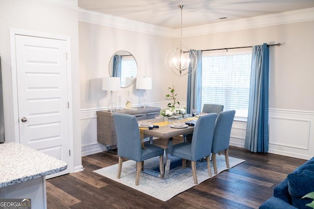 1431 Beckett Dr, Hampton, GA 30228 - dining area featuring a chandelier, crown molding, a wainscoted wall, dark wood finished floors, and a decorative wall