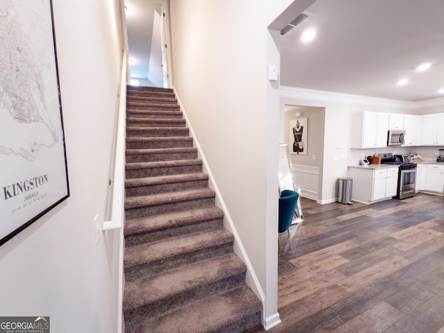 1431 Beckett Dr, Hampton, GA 30228 - stairs featuring wood finished floors, crown molding, baseboards, and recessed lighting
