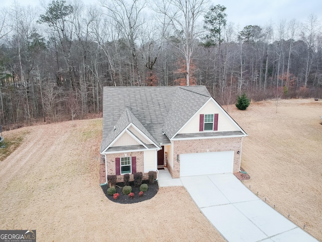 1431 Beckett Dr, Hampton, GA 30228 - traditional-style house featuring brick siding, concrete driveway, a shingled roof, and a forest view