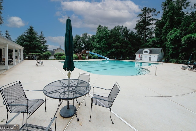 1431 Beckett Dr, Hampton, GA 30228 - community pool featuring a water slide and a patio area