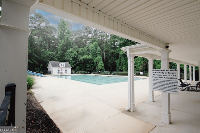 1431 Beckett Dr, Hampton, GA 30228 - community pool featuring a patio area, an outdoor structure, and a water slide