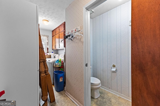 75 Antioch Rd, Mcdonough, GA 30252 - bathroom with a textured ceiling, toilet, wallpapered walls, and baseboards