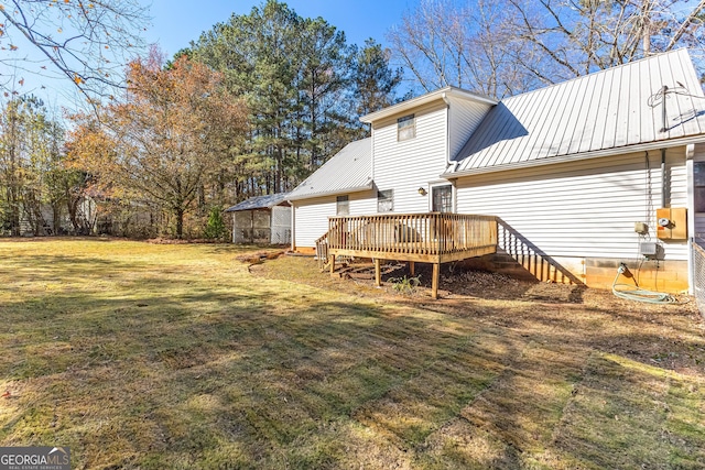 75 Antioch Rd, Mcdonough, GA 30252 - back of property featuring a wooden deck, a lawn, and metal roof