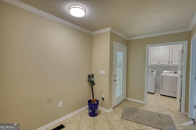 1226 Hull Rd, Athens, GA 30601 - laundry room featuring washing machine and clothes dryer, a textured ceiling, light tile patterned flooring, ornamental molding, and cabinet space