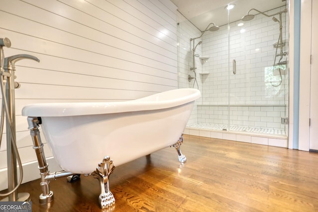 1226 Hull Rd, Athens, GA 30601 - bathroom with wood finished floors, a soaking tub, a stall shower, and wood walls