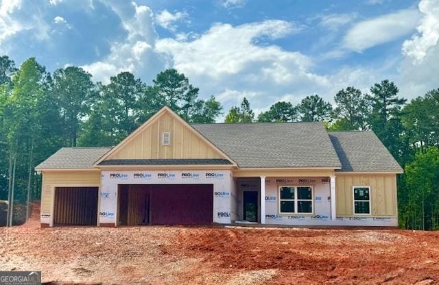 757 Belle Vis, Monroe, GA 30656 - property under construction with board and batten siding, a garage, covered porch, and roof with shingles