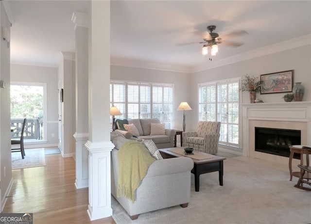 21 Devin Ln, Euharlee, GA 30145 - living area with crown molding, ornate columns, a ceiling fan, a fireplace with flush hearth, and light wood-type flooring