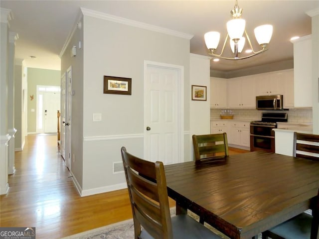 21 Devin Ln, Euharlee, GA 30145 - dining room featuring a chandelier, crown molding, and light wood finished floors
