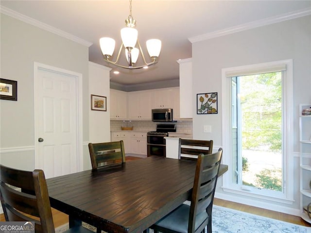 21 Devin Ln, Euharlee, GA 30145 - dining space featuring a chandelier, ornamental molding, and light wood-style flooring