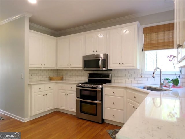 21 Devin Ln, Euharlee, GA 30145 - kitchen featuring stainless steel appliances, light wood-type flooring, crown molding, light countertops, and white cabinets