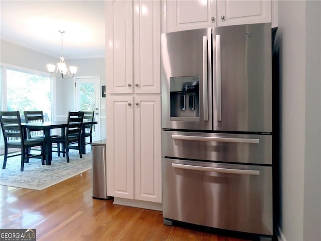 21 Devin Ln, Euharlee, GA 30145 - kitchen with stainless steel refrigerator with ice dispenser, a chandelier, white cabinets, light wood-style flooring, and decorative light fixtures