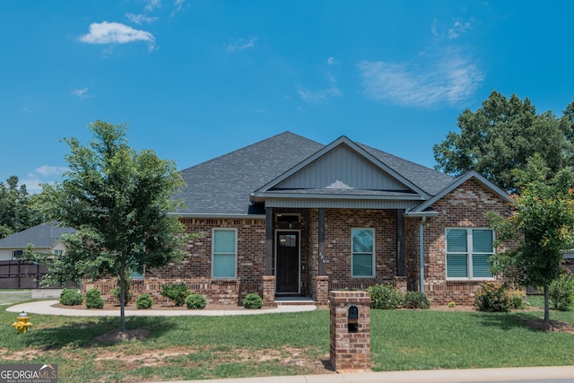 406 Clifton Rd, Perry, GA 31069 - craftsman-style home with brick siding, a front yard, roof with shingles, and board and batten siding